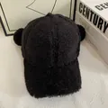 Detailed view of the soft black plush texture and cute round ears on a winter baseball cap - M (56-58cm) / Black