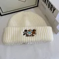 Detail of cute dog embroidery and Join My Joy text on cream knit winter beanie - M / White