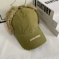 Detailed close-up of army green aviator hat with soft brown faux fur and top adjustment strap - M (56-58cm) / Green