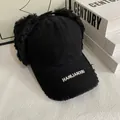 Detail of black canvas baseball hat with plush earflaps and white HANLIANXIU embroidery - M (56-58cm) / Black