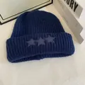 Detalle de cerca del gorro de punto azul marino con parches de estrellas y lana gruesa - M / Azul marino