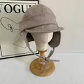 Retro beige wool plaid earflap hat with textured tweed finish on a wooden display - M(56-58cm) / Khaki