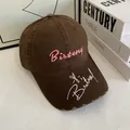 Detail of dark coffee washed cotton baseball cap with pink embroidery and frayed brim edge - M (56-58cm) / Coffee