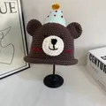 Detailed macro view of handmade brown crochet bear hat with mini party cone topper - M(56-58cm) / Coffee
