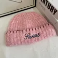 Close-up of pink mohair knit beanie with blue Sweet embroidery and red hand-stitched detail - M(56-58cm) / Pink