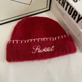 Detail of red mohair knit beanie featuring white Sweet letter embroidery and stitch trim - M(56-58cm) / Burgundy