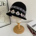Detailed close-up of vintage jacquard knit bucket hat with colorful patterns on soft fabric - M (56-58cm) / Black