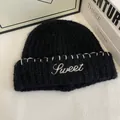 Detailed close-up of a black knit beanie featuring white 'Sweet' letter embroidery - M(56-58cm) / Black