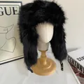 Detail of black faux fur trapper hat featuring soft texture and side buckle closure - M / Black