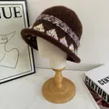 Close-up of brown knit bucket hat with bohemian patterns on a white mannequin head - M (56-58cm) / Coffee
