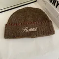 Detail of dark brown knit beanie with white Sweet embroidery and red stitch accents - M(56-58cm) / Coffee