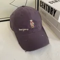 Detail of cartoon bear embroidery and distressed brim on purple cotton baseball cap - M / Gray
