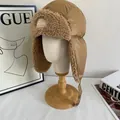 Macro view of plush faux fur lining and adjustable chin strap on quilted trapper hat - M (56-58cm) / Coffee