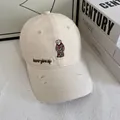 Detail of cream baseball cap featuring bear embroidery and never give up label - M / Off White