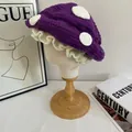 Detail of purple mushroom crochet hat with white dots and ruffled brim on stand - M (56-58cm) / Purple