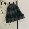 Detail of argyle knit beanie featuring green and purple diamond pattern and ribbed texture - M (56-58cm) / Green