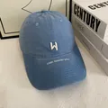 Detailed embroidery of white W letter and walk beside you text on navy cotton cap - M / Blue