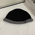 Detail of two-tone ribbed knit beanie with snowflake patch and gray folded cuff - M (56-58cm) / Black