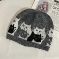 Close-up of grey knitted beanie featuring cat jacquard pattern and fuzzy mohair texture - M / Dark Gray