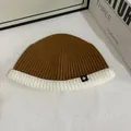 Detail view of contrast knit beanie with brown and cream textures and snowflake patch - M (56-58cm) / Camel