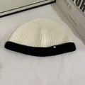Close-up of contrast knit beanie texture with snowflake patch and ribbed cuff - M (56-58cm) / White