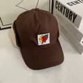 Detailed view of dark brown ear flap baseball cap with soft faux lamb wool lining and embroidery - M (56-58cm) / Coffee