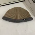 Close-up of ribbed knit texture on two-tone camel and grey beanie with snowflake tag - M (56-58cm) / Khaki