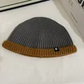 Close-up of contrast knit beanie with grey body, brown cuff and snowflake logo detail - M (56-58cm) / Gray