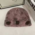Detail of pink tie-dye knit beanie featuring distressed holes and thick ribbed texture - M / Pink