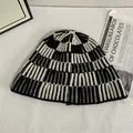 Chic black and white striped knitted bucket hat for women on white textured surface - M(56-58cm) / Black