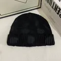 Close-up of black distressed knit beanie with ribbed texture and frayed edge details - M / Black