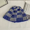 Detail of blue and beige striped knit bucket hat showing soft woolen texture and weave - M(56-58cm) / Blue