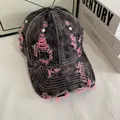Detail of distressed denim baseball cap featuring unique ripped fabric and pink stitching - M (56-58cm) / Pink