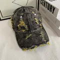 Close-up of distressed denim baseball cap with yellow frayed details and vintage wash effect - M (56-58cm) / Yellow