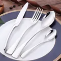 Polished black and gold stainless steel cutlery set with knife, fork and spoons - Silver