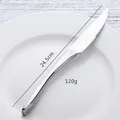 Polished 304 stainless steel steak knife, 24.5cm long and 120g weight, on ceramic plate - Silver Knife