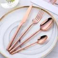 Modern rose gold stainless steel cutlery set with V-shaped handles on a marble background - Rose Gold