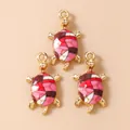 Three gold sea turtle pendants with colorful enamel patterns for DIY jewelry making - Red Turtle