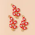 Macro view of red enamel evil eye leaf charms with gold plating and double connectors - Gold Red
