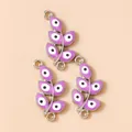 Detailed macro view of purple evil eye leaf pendants with silver metallic connectors - Silver Purple