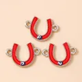 Macro detail of horseshoe connectors with red enamel and evil eye charms for DIY jewelry - Silver Red