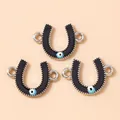 Detailed macro view of black enamel horseshoe pendants with blue evil eye charms - Silver Black