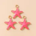 Close-up of three pink and gold starfish pendants for DIY jewelry making - Rose Red