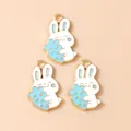 Three white cartoon rabbit alloy pendants holding carrots with gold trim DIY charms - Blue