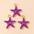 Macro detail of three purple starfish pendants with golden alloy frames for DIY jewelry - Purple