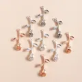 Macro detail of rose flower pendants in silver and rose gold alloy for DIY jewelry making - 10 Pieces Pack / Multicolor