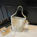 Chic beige hollow-out bucket bag with a plush dog charm and adjustable shoulder strap - 29*13*28 / Off-white Hollow Bucket Bag With Plush Pendant / Off-White with Pendant
