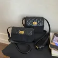 Quilted black crossbody bag with gold metal clasp and contrast material textures - L / Black