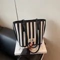 Large capacity striped tote bag with black and white vertical patterns and shoulder straps - Black