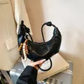 Black vegan leather crescent bag with knotted shoulder strap and vintage bead charm decoration - Black